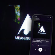 MEANINGWAVE MASTERPIECES IV digital album: cover art with a phone playing it on meaningwave.com
