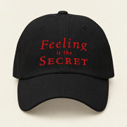 FEELING IS THE SECRET with Neville Goddard Dad Cap in Black, front