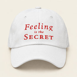 FEELING IS THE SECRET with Neville Goddard Dad Cap in White, front